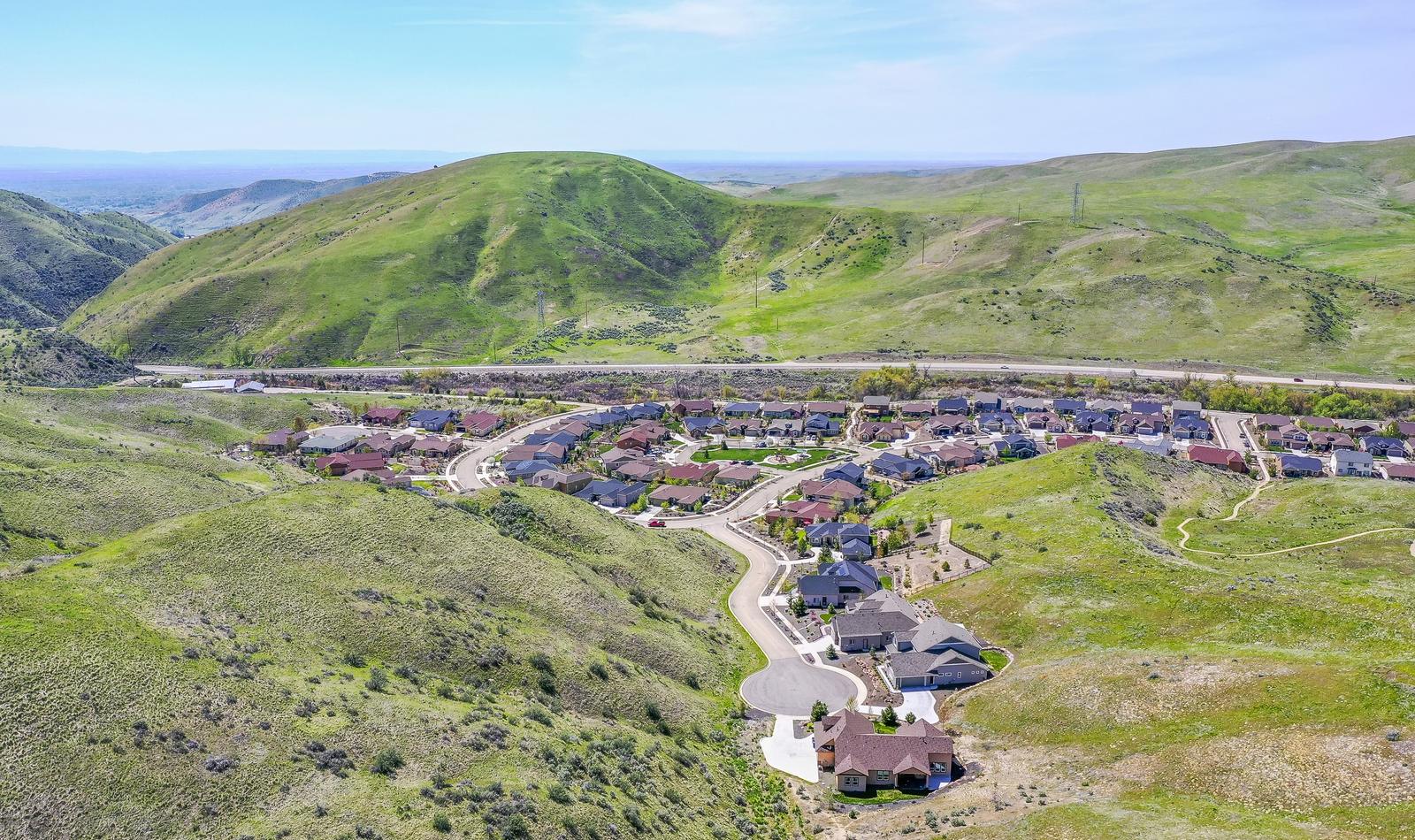 Aerial view of Avimor neighborhoods and green parks below the foothills