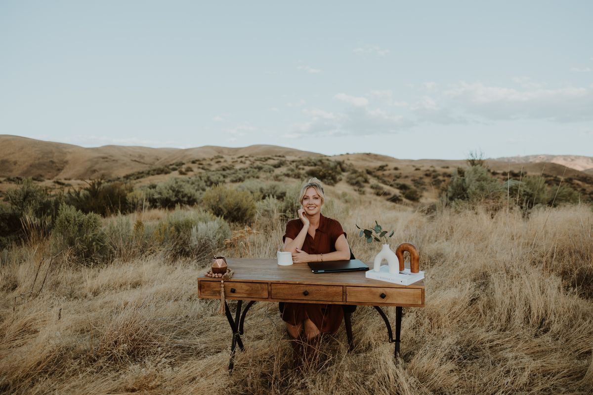 Kimberly Holland at a desk in the Boise foothills