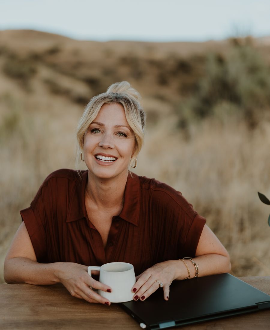 Kimberly Holland, Realtor, smiling with a cup of coffee